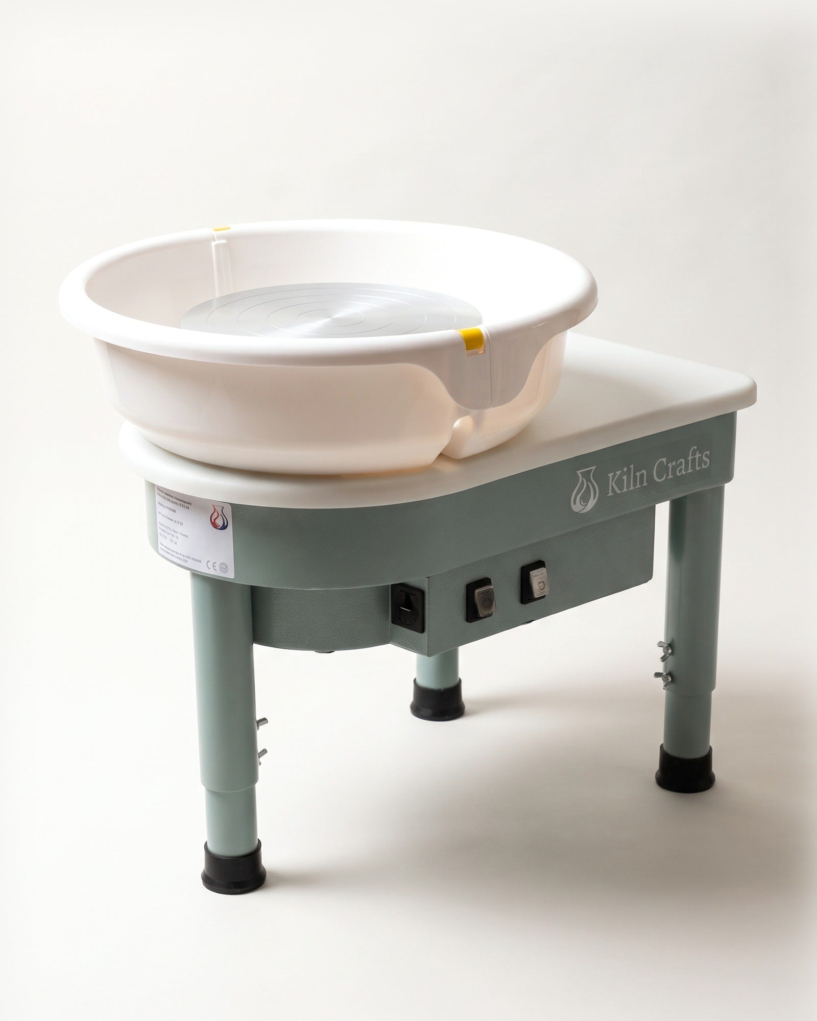 The Kiln Crafts Poppy pottery wheel in sage green with a white splash pan