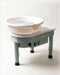 The Kiln Crafts Poppy pottery wheel in sage green with a white splash pan