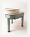The Kiln Crafts Thistle direct drive pottery wheel in sage green with a cream top