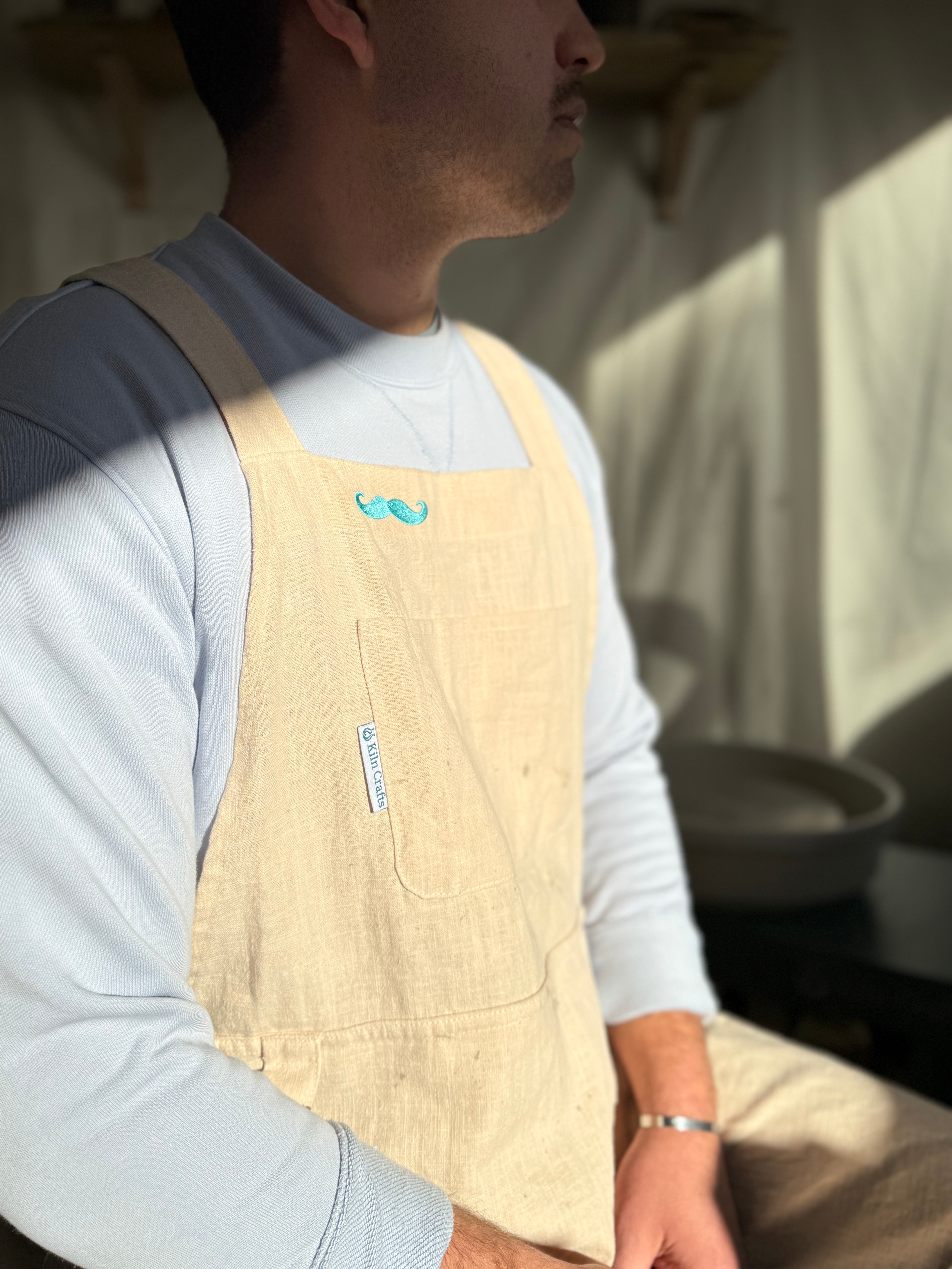 A man wearing kilncrafts apron