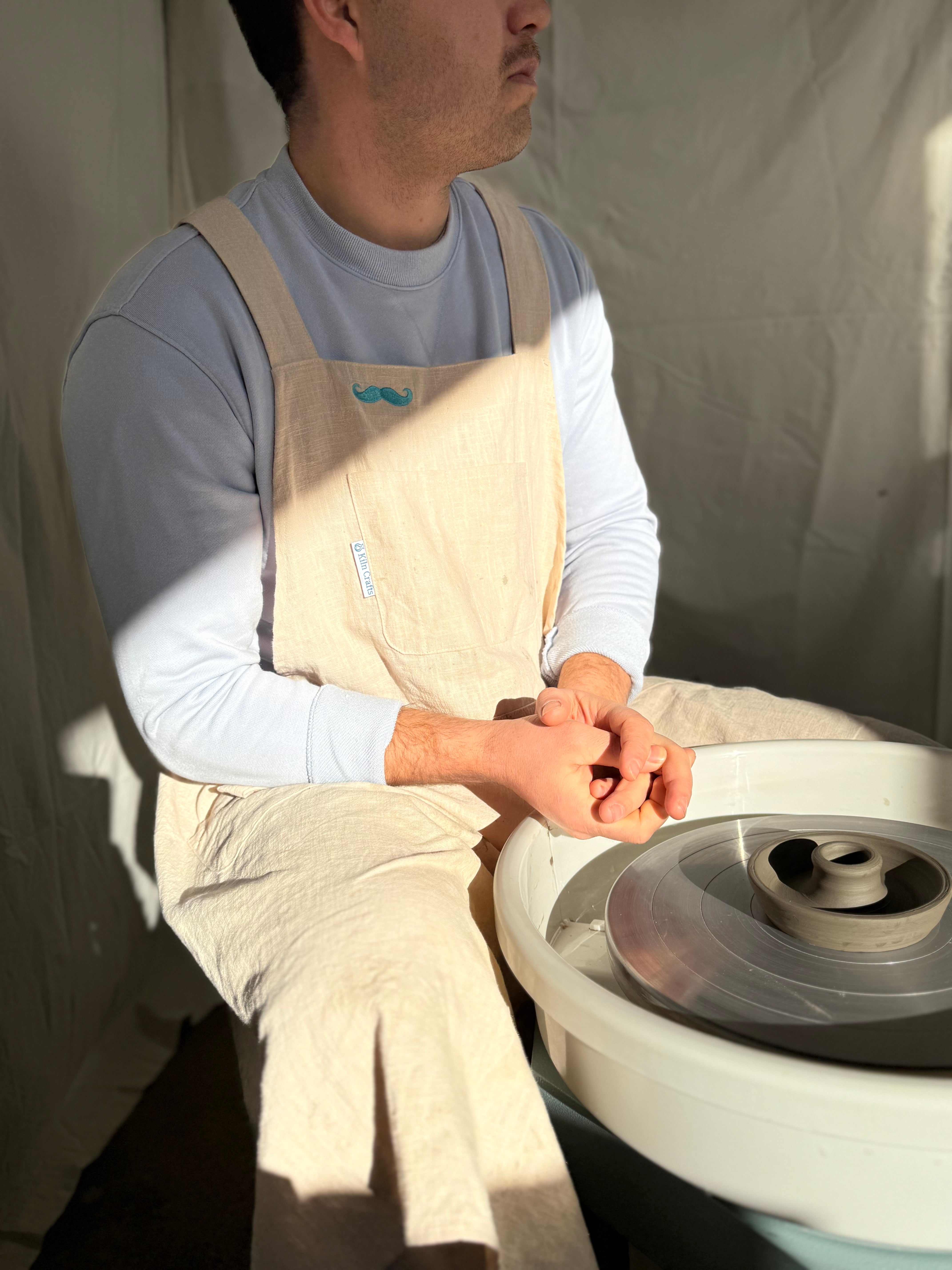 A man wearing kilncrafts apron