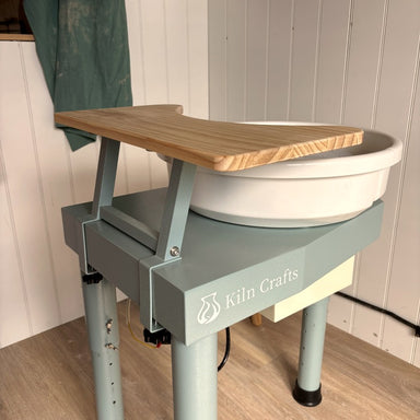 Kiln Crafts Daisy Wheel Shelf fitted to the Daisy pottery wheel — side view with wheel spinning