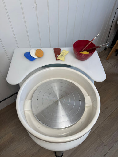 Thistle Wheel Shelf in use — ribs, sponges and a water bowl on the shelf beside the wheel head